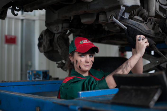 a female mechanic working on a car